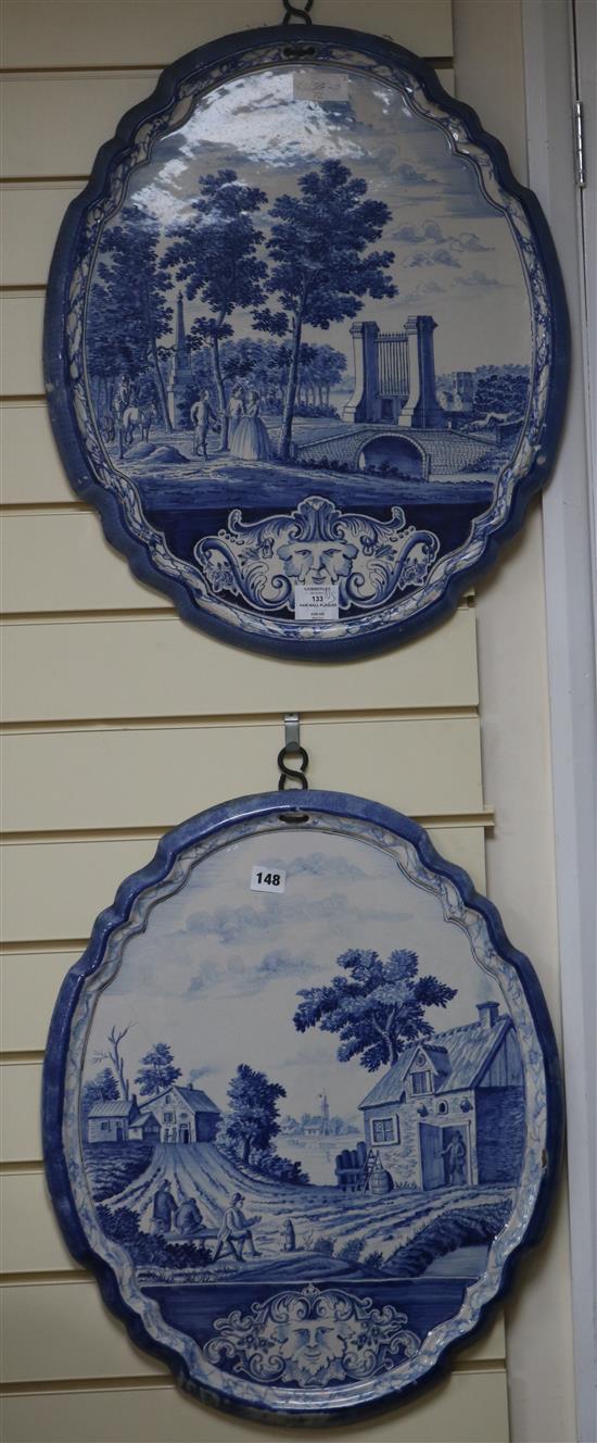 A pair of 19th century Dutch delft blue and white cartouche shaped wall plaques